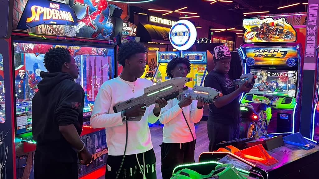 MHC Youth and PENSA members enjoying an arcade game together during their October outing