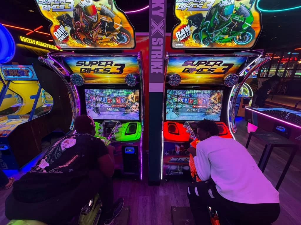 Two MHC Youth and PENSA members playing side by side on motorcycle racing machines